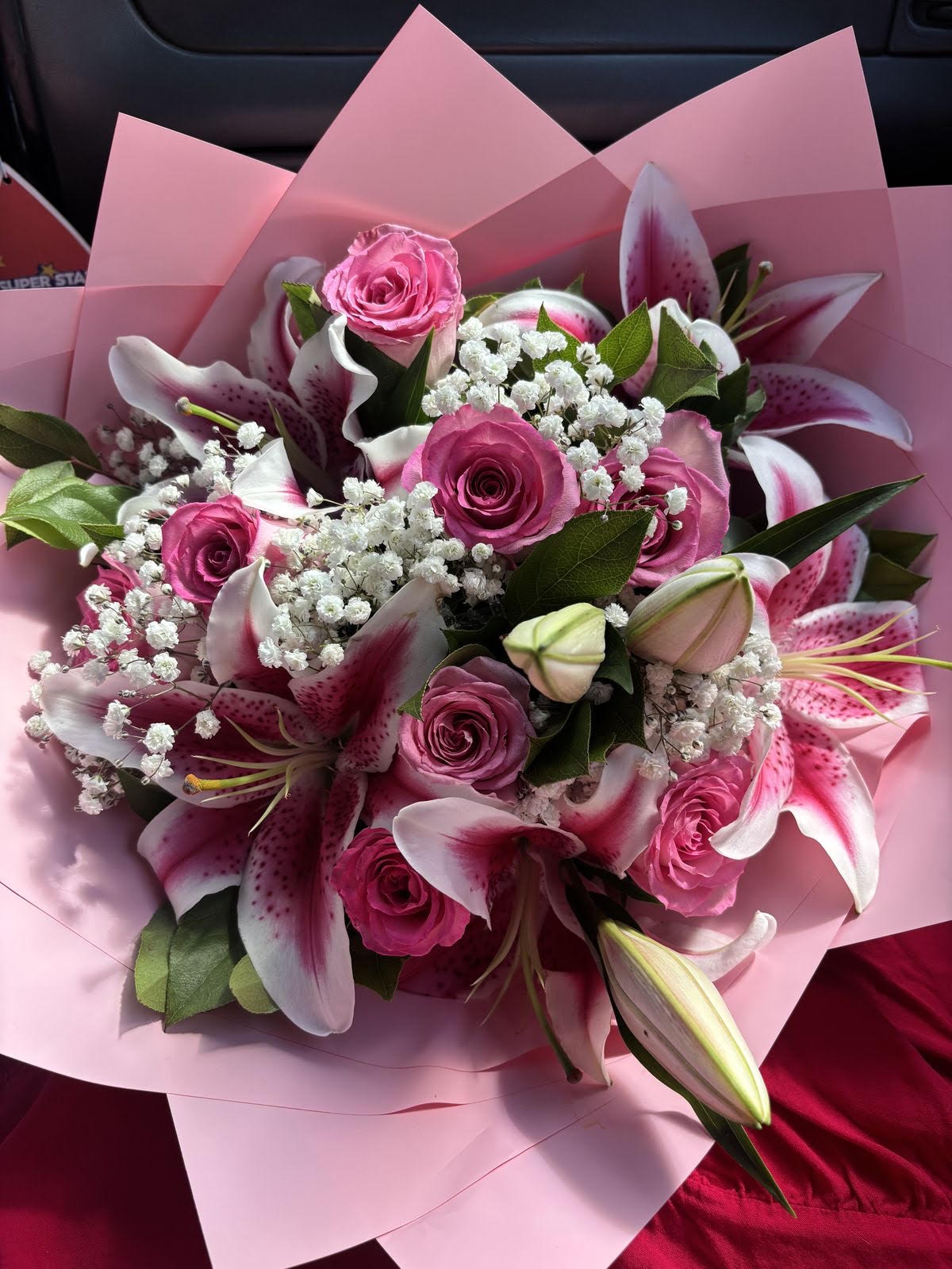 Pink roses and lilies bouquet wrapped in blush paper